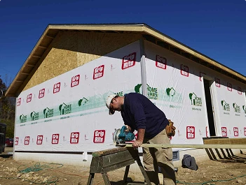 Construction worker cutting lumber