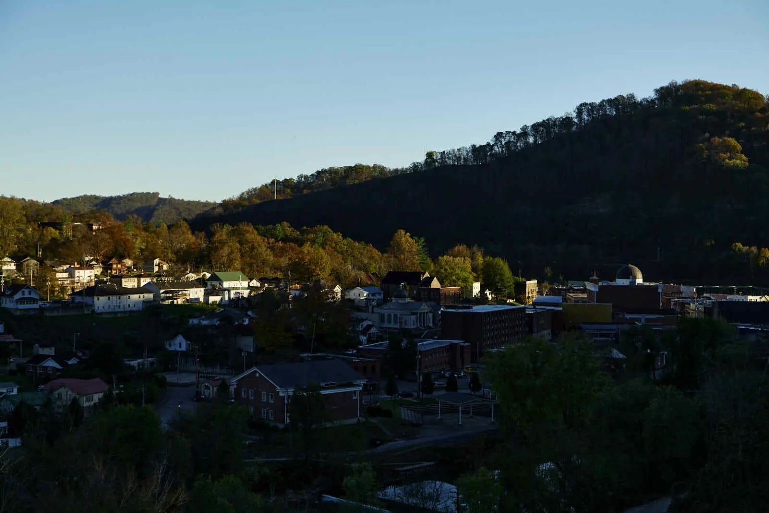 Homes scattered beneath a hill