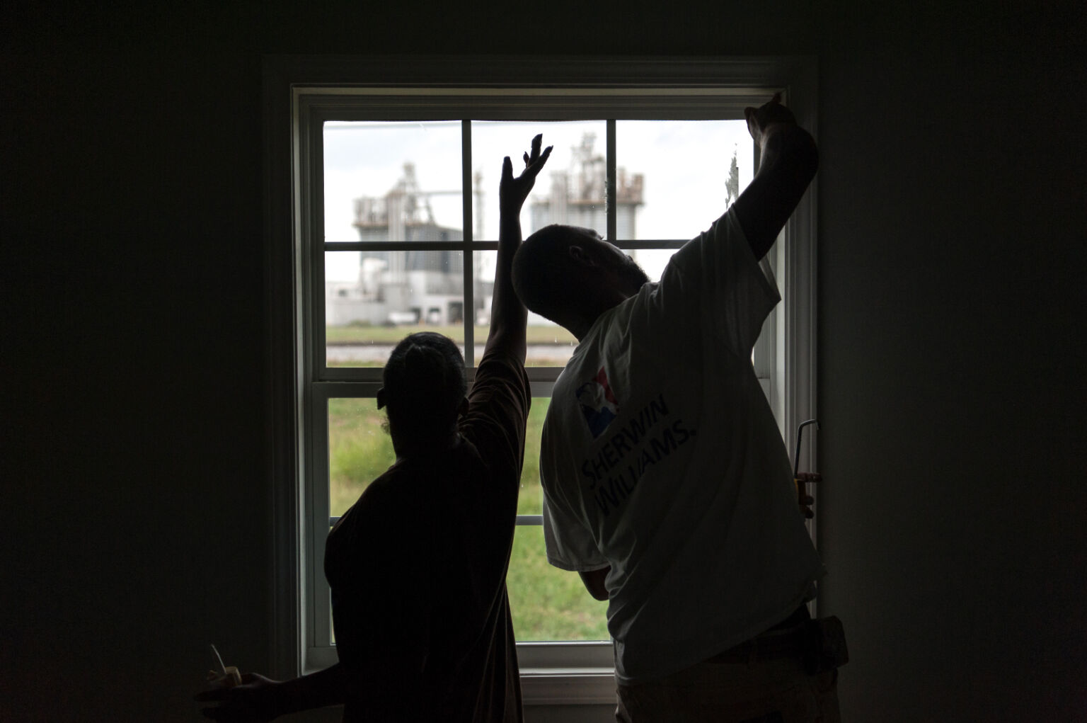 Two builders working in a window
