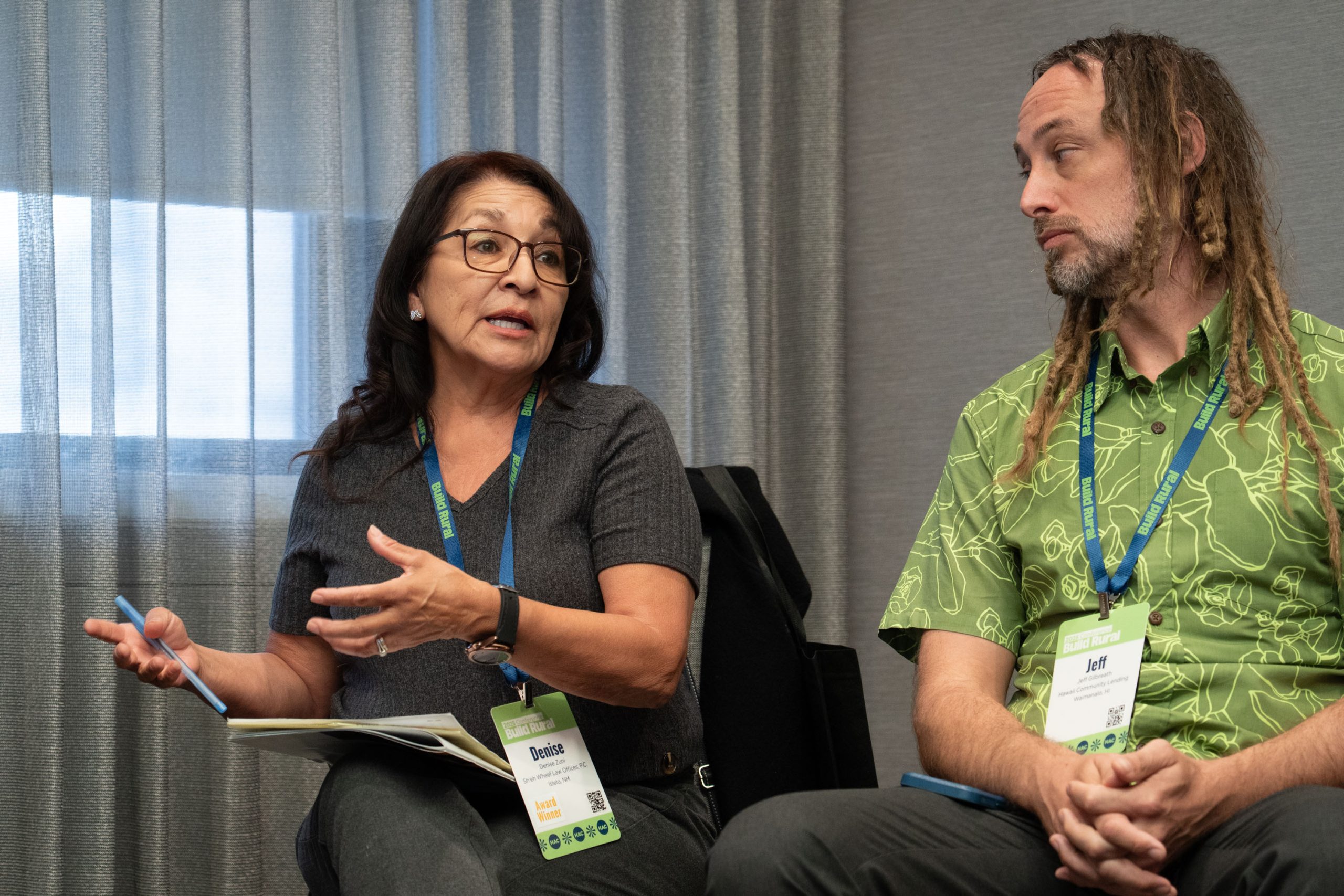 Panelists seated during a conference discussion.